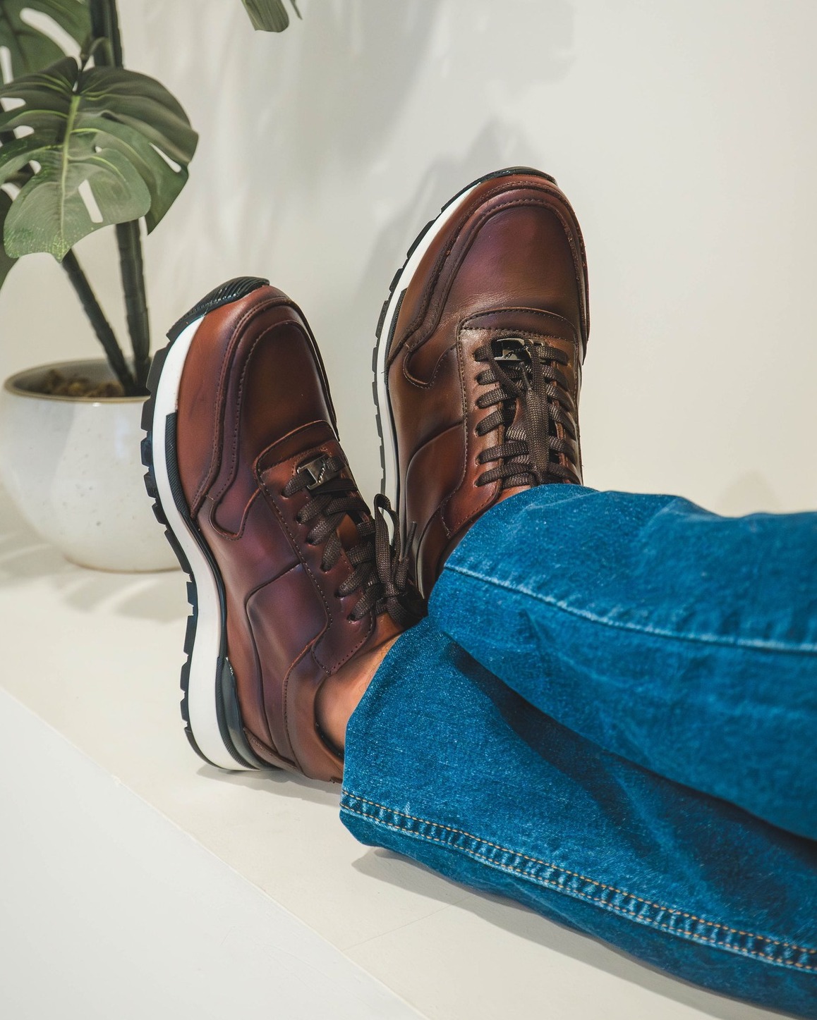 Premium leather footwear photographed in a soft editorial composition