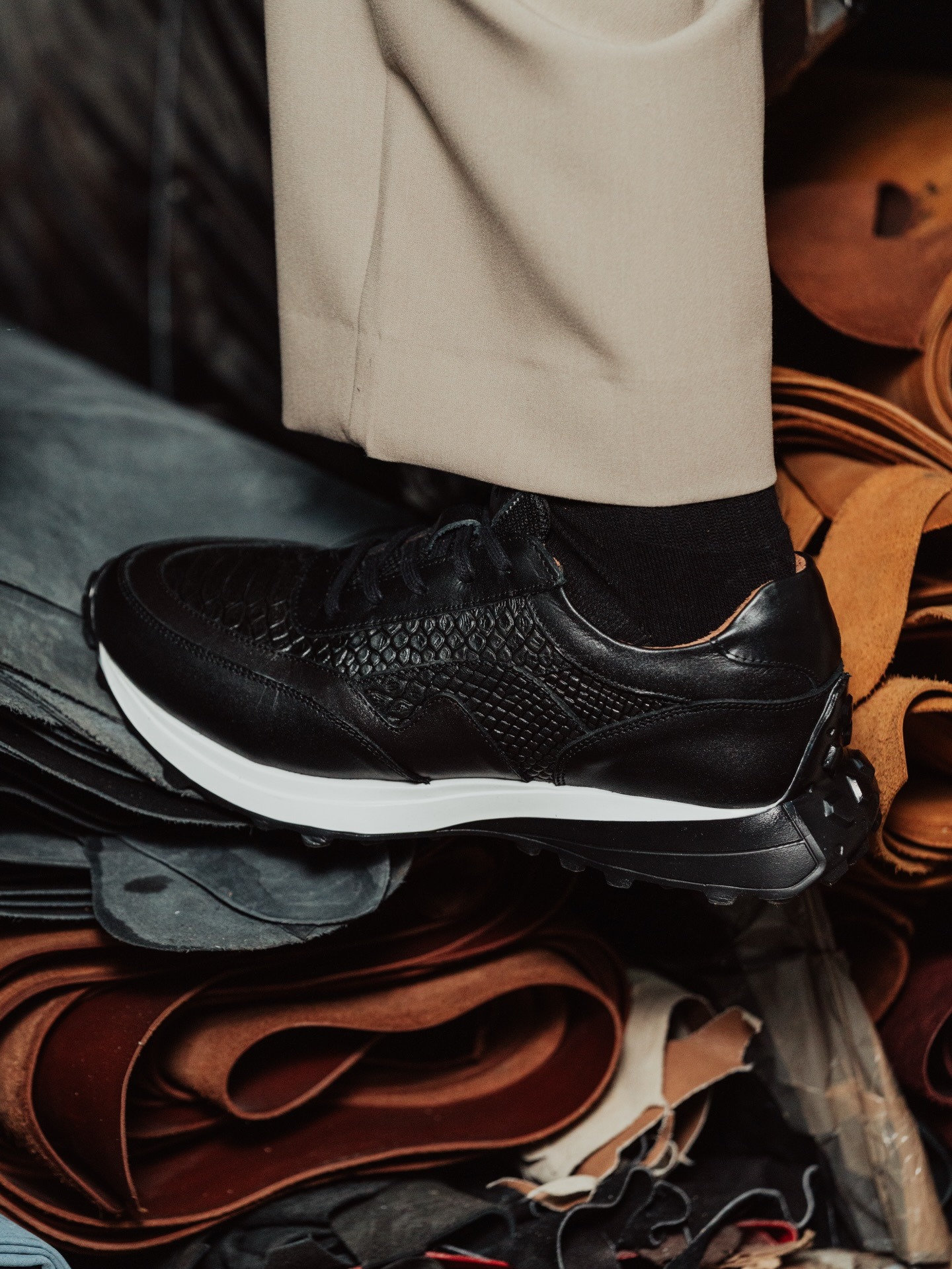 Premium leather footwear in a soft editorial composition